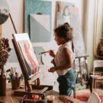 A Young Girl Looking at Her Artwork