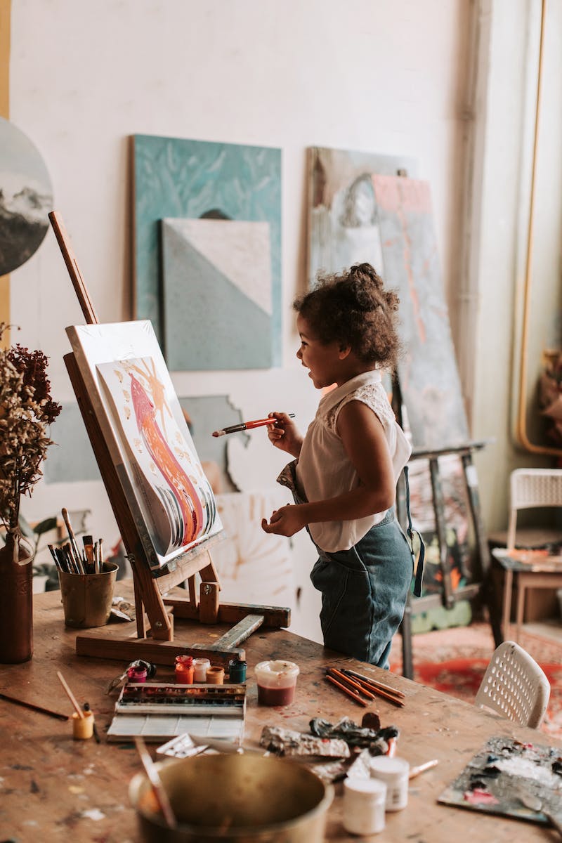 A Young Girl Looking at Her Artwork