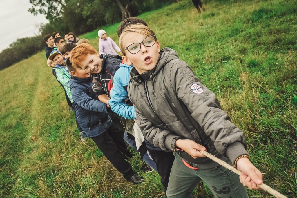 group of children pulling brown rope