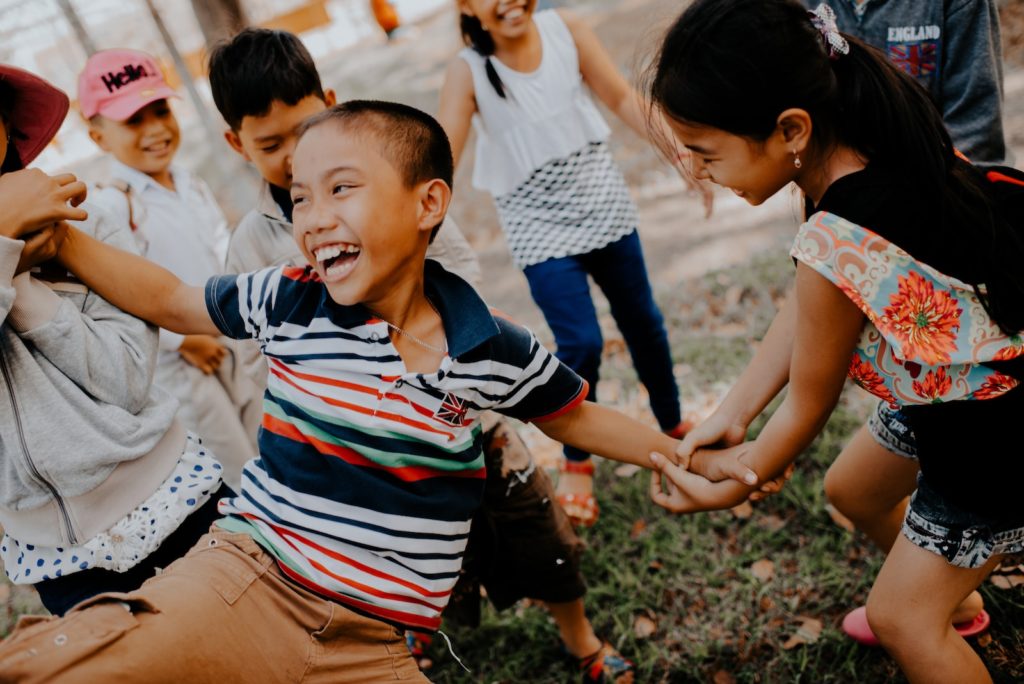 children playing on grass field