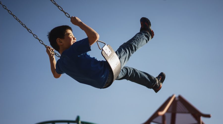 boy sitting on swing chair