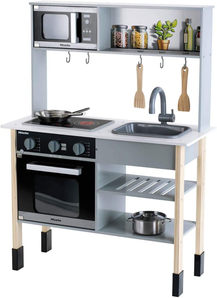 Theo Klein 7199 Miele kitchen. White wooden kitchen incl. hob with sound and light. Dimensions: 70 cm x 30 cm x 91 cm. Elegant kitchen accessories made of stainless steel (not heatable) and wood.