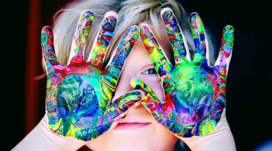 A KId With Multicolored Hand Paint