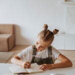 Little Girl Writing on a Notebook