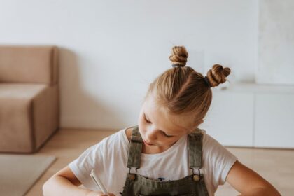 Little Girl Writing on a Notebook