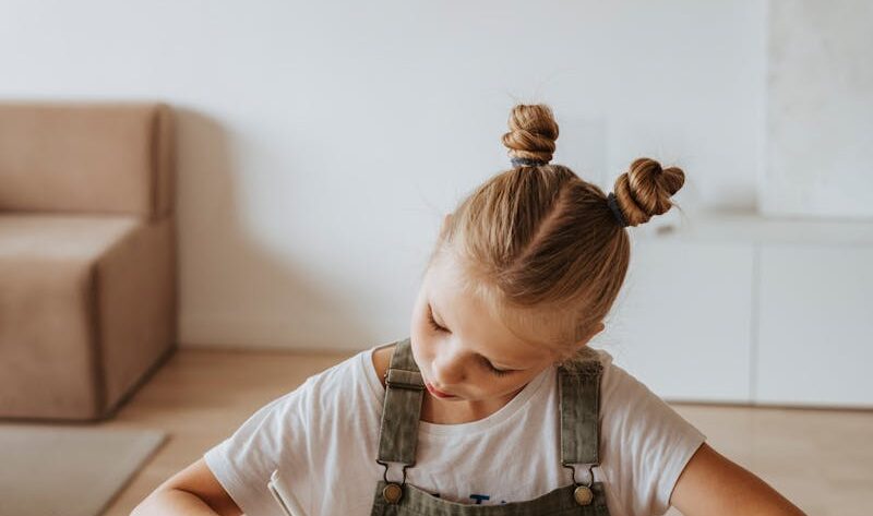 Little Girl Writing on a Notebook