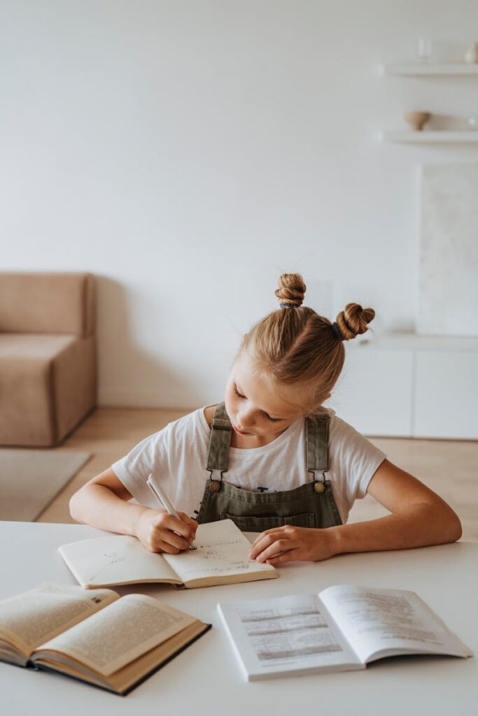 Little Girl Writing on a Notebook