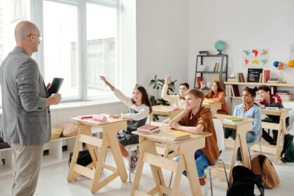 Students Raising their Hands in the Classroom