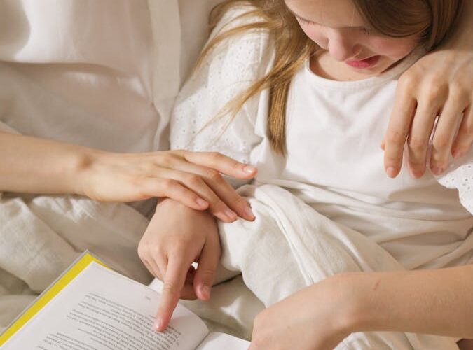 Mother and Daughter Reading a Book Together