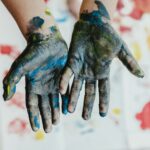 person hands with green paint