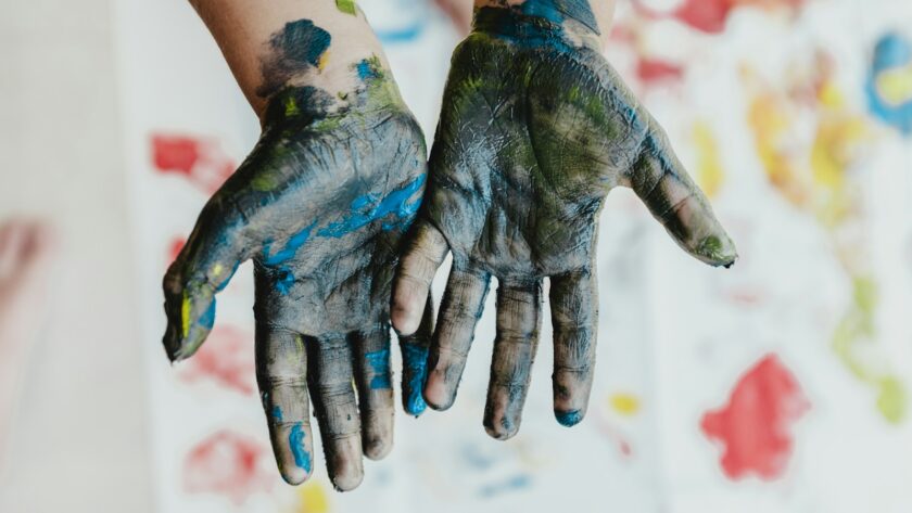 person hands with green paint