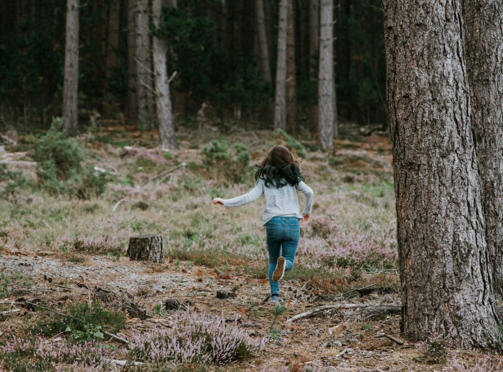 girl running in woods